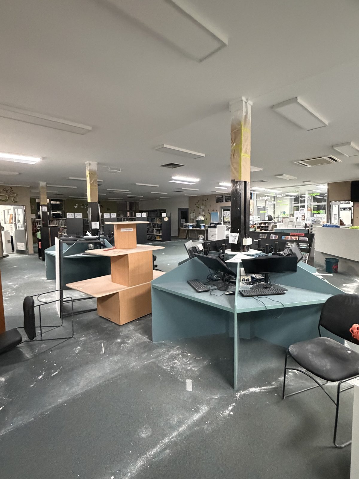 Library computer desks and floor covered in plaster dust before builders cleaning