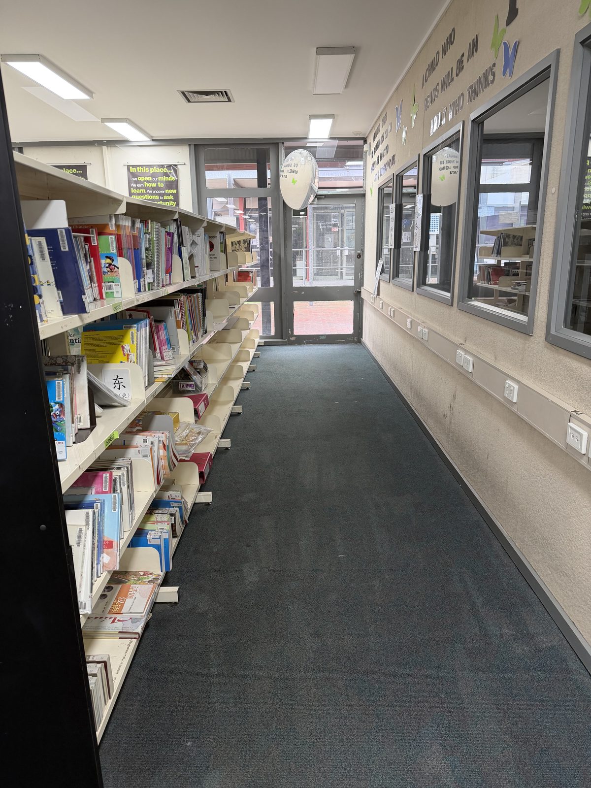 Clean carpet along the window-lined library walkway in Doncaster after end of build cleaning