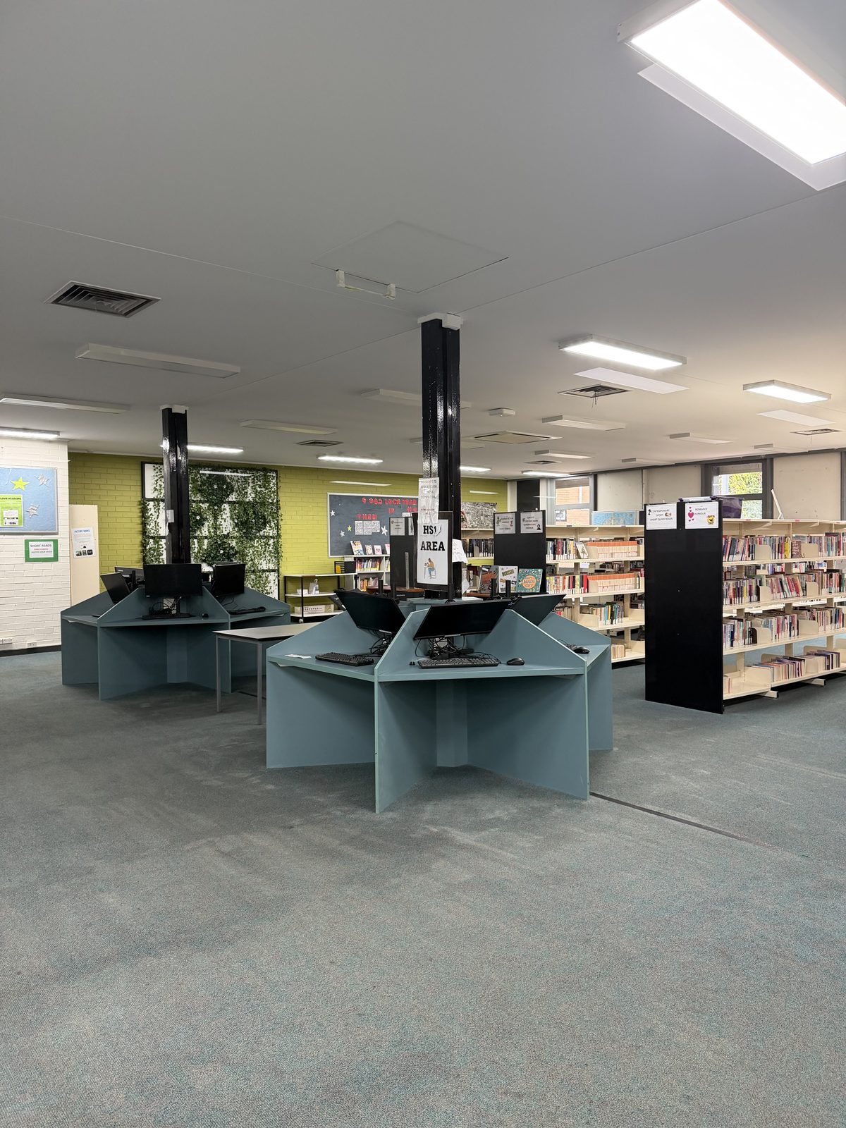 Computer study pods and cleaned green carpet in the finished library in Doncaster